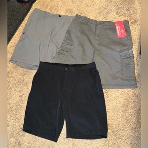 Three pairs of men’s shorts. Two gray and one black.
